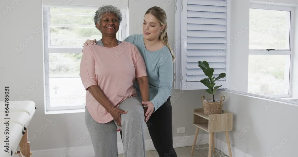 Caucasian nurse with senior woman exercising, copy space, slow motion Caucasian nurse with senior woman exercising, copy space, slow motion