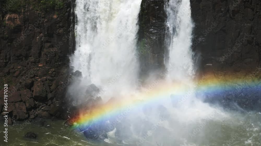 Bright Beautiful Rainbows Covered by Huge Waterfalls in Iguacu Falls, Large Bodies of Water Falling of Dark Rocky Cliff Edge onto Colourful Rainbow Arch in Iguazu Falls, Brazil Bright Beautiful Rainbows Covered by Huge Waterfalls in Iguacu Falls, Large Bodies of Water Falling of Dark Rocky Cliff Edge onto Colourful Rainbow Arch in Iguazu Falls, Brazil