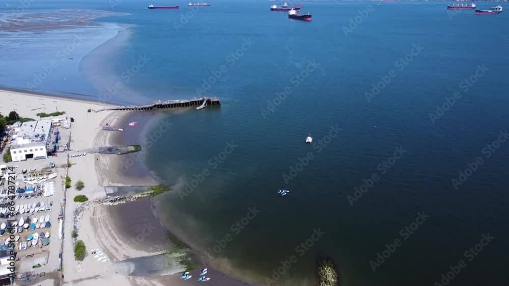 Flying over Locarno Beach towards ships sitting in the burrard inlet Flying over Locarno Beach towards ships sitting in the burrard inlet