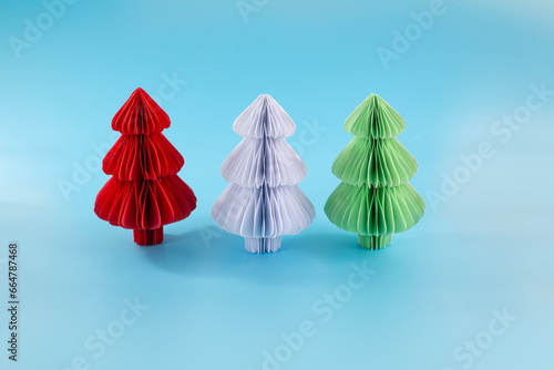 three color christmas trees craft on a blue background