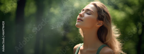Relaxed happy young woman breathing fresh air deep with a green forest. 
