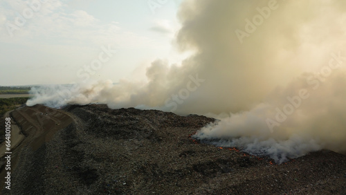 Flying a drone over a fire that occurred at a landfill on the island of Bali. Plastic waste is burning, a real environmental disaster. Garbage recycling and waste disposal.