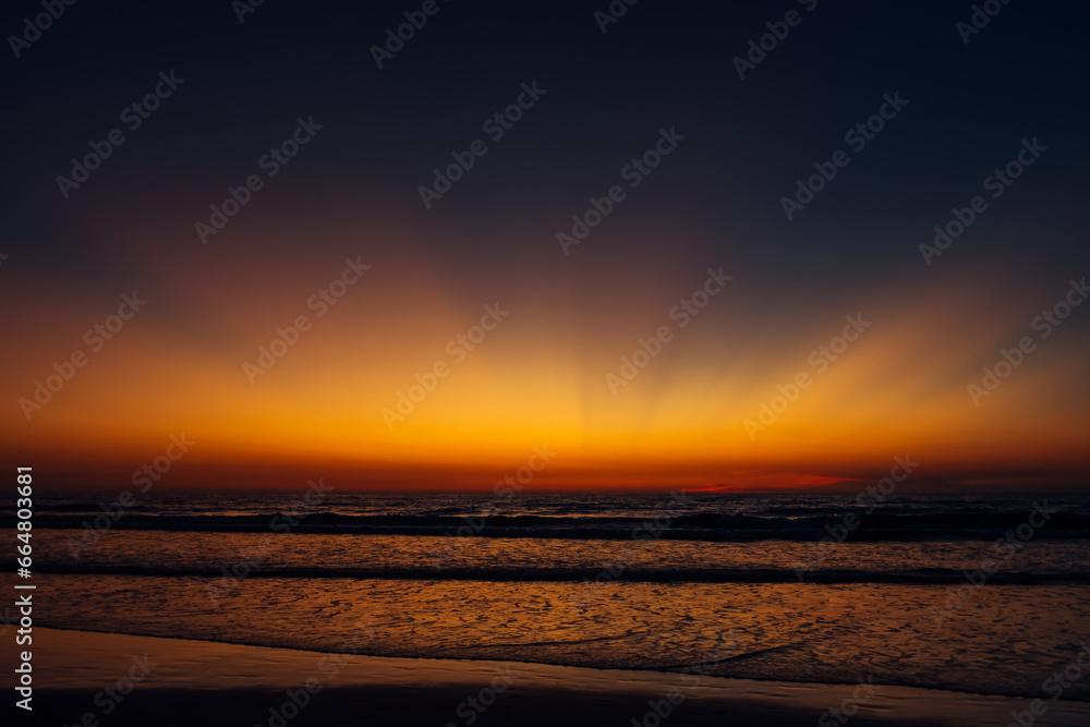 Colorful twilight over the sea. Stunning sunset on the ocean coast. Evening sky.