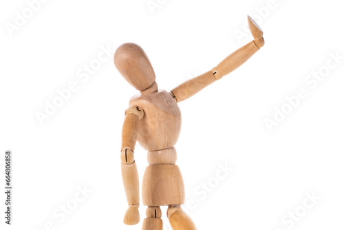 A wooden mannequin standing on a white surface. This picture can be used for various creative projects and design purposes.