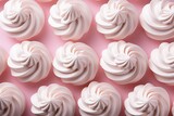 A lot of meringue on a pink background close-up. View from above. Elegant meringue curls
