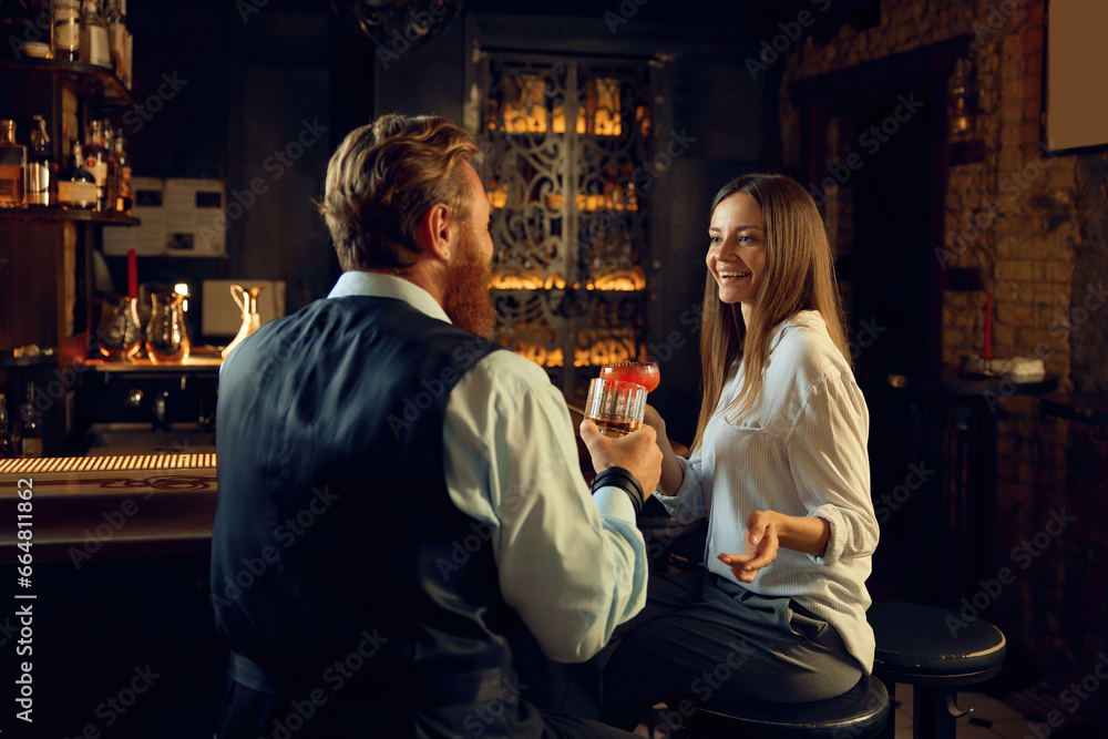 Man and woman having nice conversation at bar counter