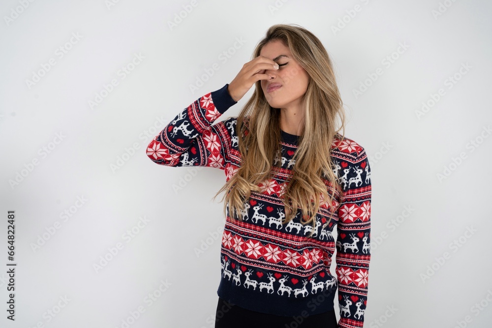 Sad Young beautiful woman suffering from headache holding hand on her face Sad Young beautiful woman suffering from headache holding hand on her face