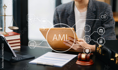 AML Anti Money Laundering Financial Bank Business Concept. judge in a courtroom using laptop and tablet with AML anti money laundering icon on virtual . photo