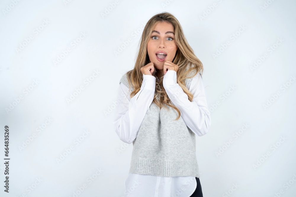 Young business woman wearing formal clothing celebrating surprised and amazed for success with arms raised and open eyes. Winner concept. Young business woman wearing formal clothing celebrating surprised and amazed for success with arms raised and open eyes. Winner concept.