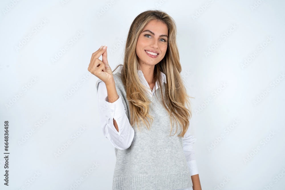 Young beautiful woman pointing up with hand showing up seven fingers gesture in Chinese sign language QÄ«. Young beautiful woman pointing up with hand showing up seven fingers gesture in Chinese sign language QÄ«.
