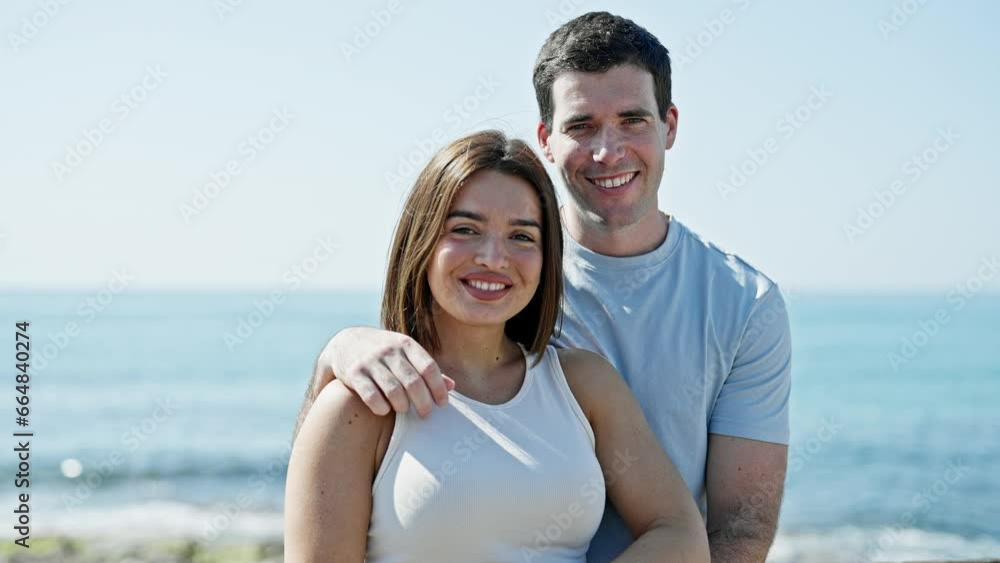Beautiful couple smiling confident hugging each other at seaside Beautiful couple smiling confident hugging each other at seaside