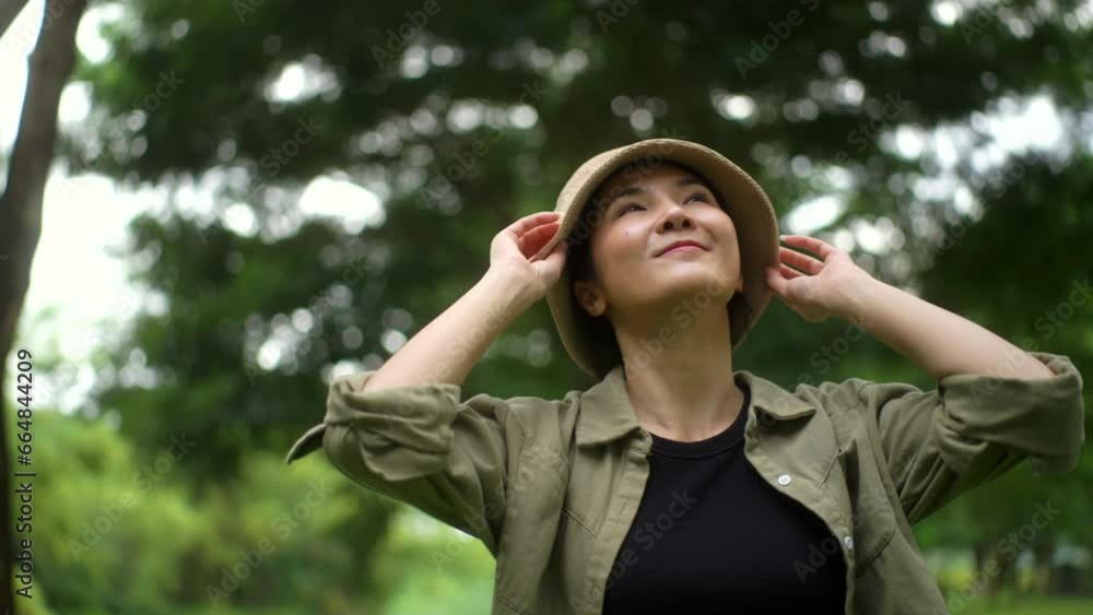 Happy woman Breathing the fresh air on his vacation weekend holiday trip tree at park. Asian female traveller relaxing in nature forest. Human and natural.