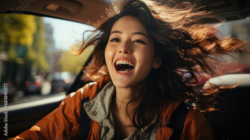 Beautiful Asian woman gets a new car She is very happy and excited. Woman driving a car smiling on the road on a bright day © Morng