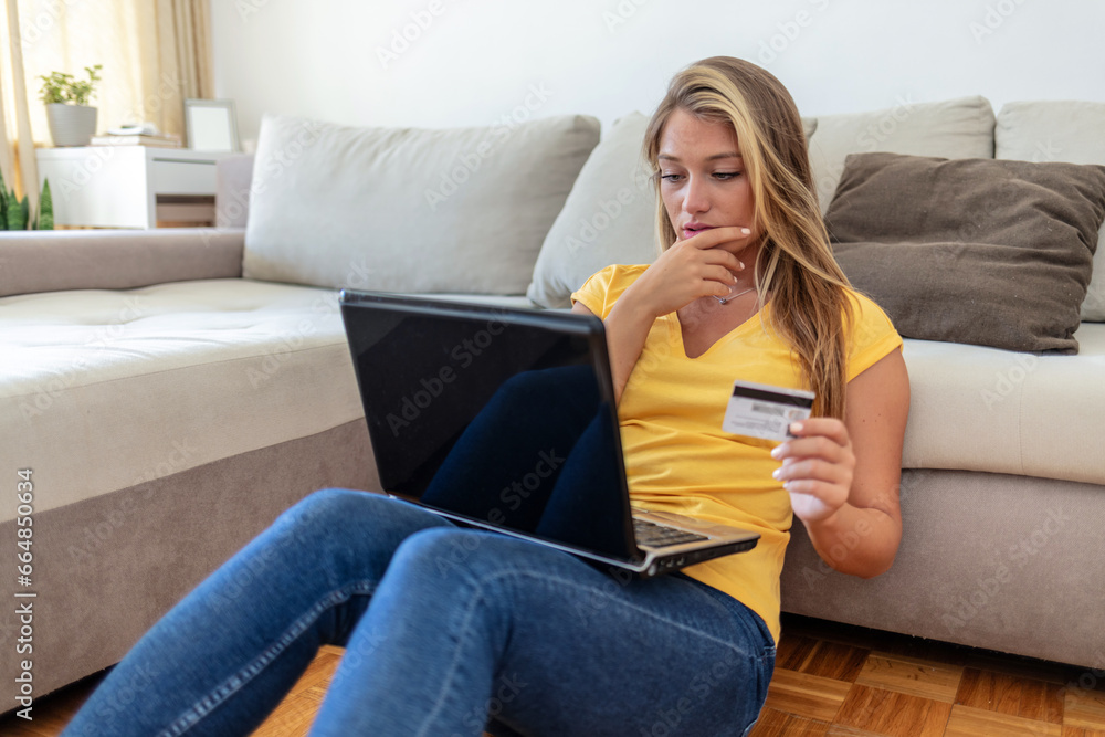 Worried young woman using online banking service, problem with blocked credit card, using laptop, irritated girl checking balance, internet fraud concept, bankruptcy or debt, overspend.