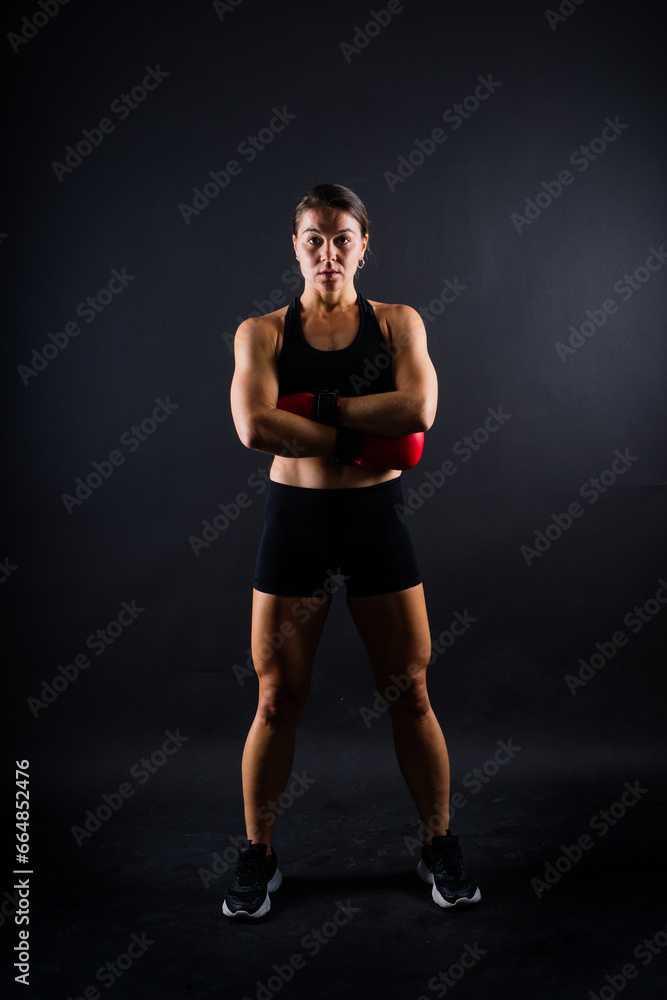 Young woman athletic female MMA fighter training. Concept of sport, action, healthy lifestyle.