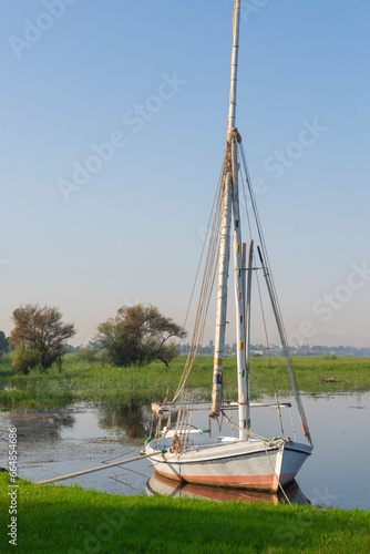 Wooden felluca sailing boat moored on river bank