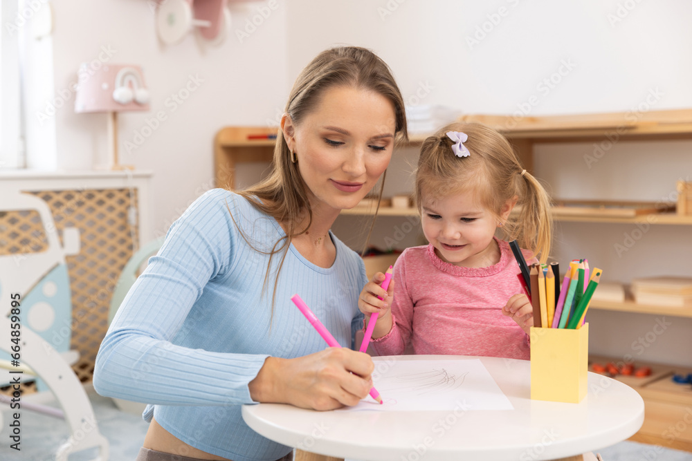 Mother draws with her toddler child Mother draws with her toddler child