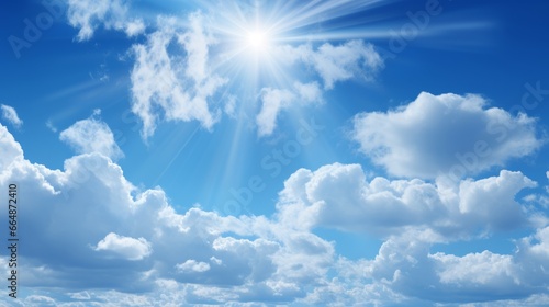 Clear blue skies with fluffy white clouds. Summer sunlight creates a beautiful and bright atmosphere. The wind gently moves the clouds  creating a scenic pattern in the sky. A perfect sunny day