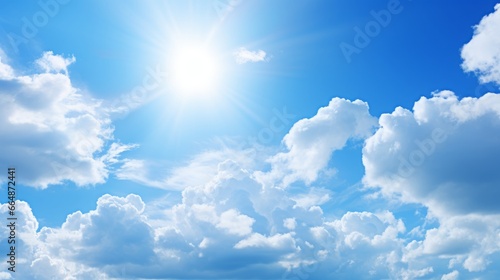 Clear blue skies with fluffy white clouds. Summer sunlight creates a beautiful and bright atmosphere. The wind gently moves the clouds, creating a scenic pattern in the sky. A perfect sunny day