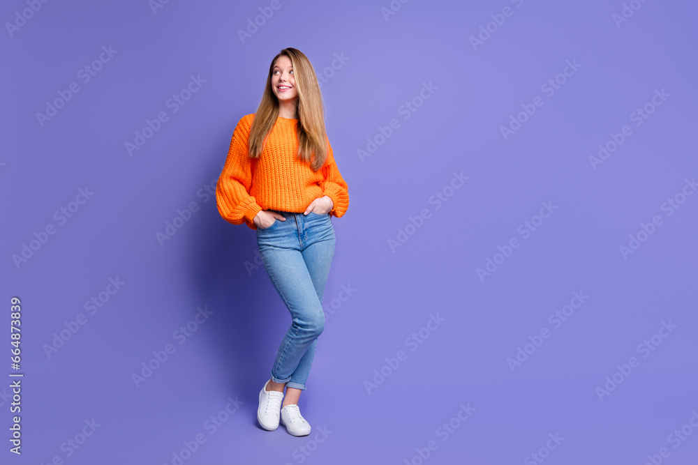 Full length portrait of adorable minded girl put hands pockets look empty space isolated on purple color background