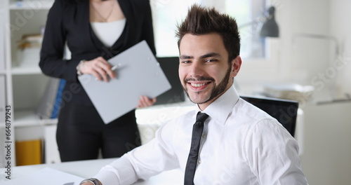 Portrait of handsome man work at office with assistant photo