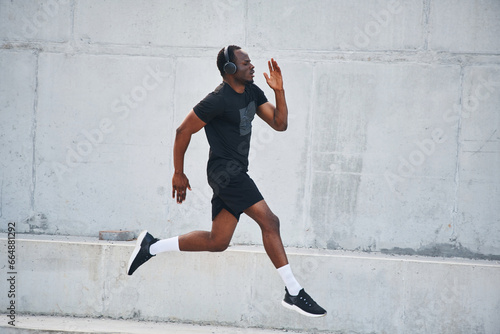 Sportive black man is running, morning routine
