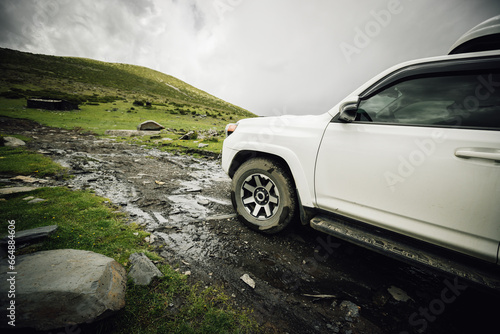 Driving off road car in high altitude mountains in Sichuan province, China photo