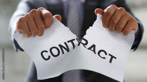 White collar worker in suit and tie tear contract closeup. Get jobless arm form rip job loss customer offer human resources staff reduction service failure legal trouble attitude concept