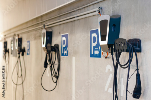 Charging Station for Electric Cars in Private Garage of Multifamily Building. Autonomous Refueling Charging Station for Electro Car in Underground Parking lot with Control Panel, Electric Meter.