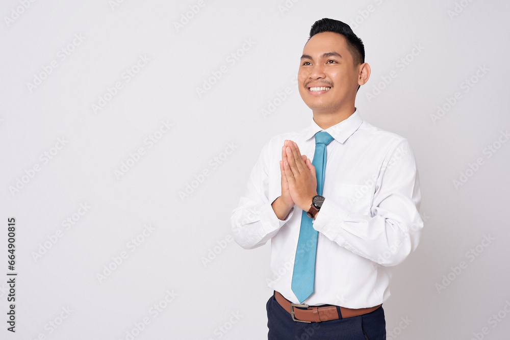 Smiling happy Asian businessman wearing formal shirt and tie standing confident while showing welcome gesture with hands isolated on white background Smiling happy Asian businessman wearing formal shirt and tie standing confident while showing welcome gesture with hands isolated on white background