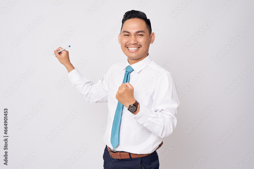 Excited young Asian businessman wearing formal shirt and tie holding pen while presenting and motivating team isolated on white background Excited young Asian businessman wearing formal shirt and tie holding pen while presenting and motivating team isolated on white background