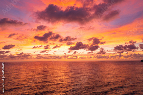 exotic pink red sky in sunset at Karon beach Phuket..Scene of colorful romantic sky sunset with changing the brilliant yellow sky gradually turned red. .beautiful sky of sunset in nature and travel 