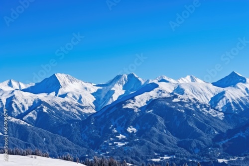 the swiss alps covered in snow under a clear  blue sky