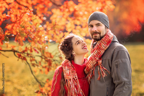 happy romantic couple in the autumn park   newlyweds  holidays  love  travel  tourism  relationship and dating concept