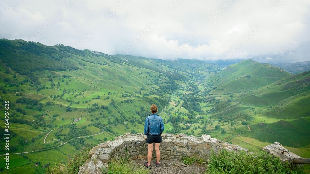 hiker looking at the valley from the viewpoint in Portillo de Lunada, Cantabria, Spain