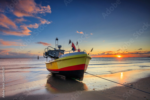 Fishing boats on the beach of Baltic Sea in Sopot at sunrise, Poland