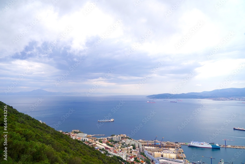 view over the roofs of Gibraltar to the Bay of Gibraltar and the Strait of Gibraltar with Morocco at the left side and Algeciras in Andalusia, Spain on the right side