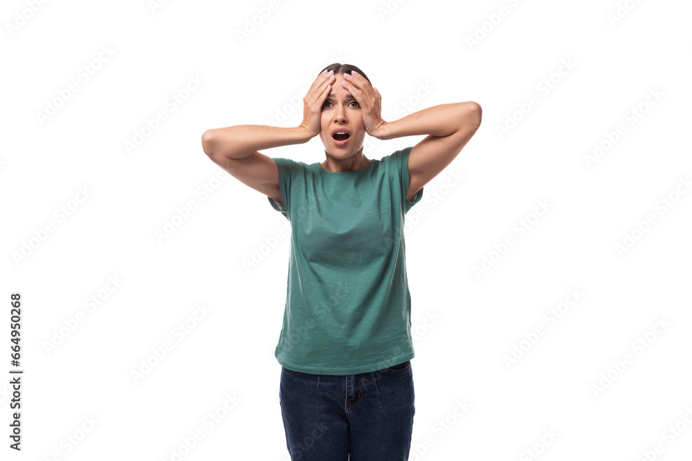 young excited black-haired woman with collected hair is dressed in a basic t-shirt and jeans holding her head young excited black-haired woman with collected hair is dressed in a basic t-shirt and jeans holding her head