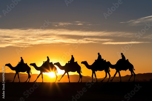 a silhouette of a camel caravan in the setting sun