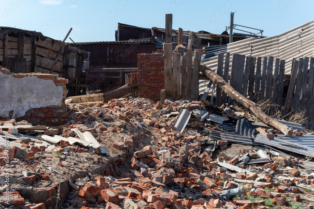 An old ruined wooden house. Broken walls, a ruined roof. Piles of garbage. Natural disasters, war, earthquake An old ruined wooden house. Broken walls, a ruined roof. Piles of garbage. Natural disasters, war, earthquake