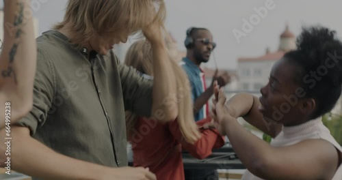 Wallpaper Mural Carefree students enjoying open air party on roof dancing while DJ playing trendy music on summer day. Happy youth and leisure activity concept. Torontodigital.ca