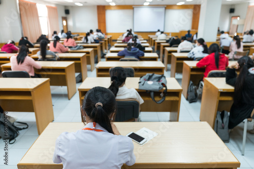 Selective focus high school or university students concentrate on language listening test in the examination hall
