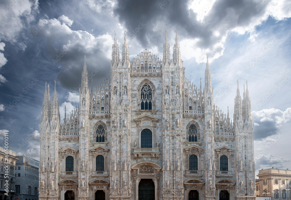 Duomo di Milano, the splendid cathedral of Milan city, Italy, also known as Basilica of the Nativity of Saint Mary, during a day with dark clouds. Duomo di Milano, the splendid cathedral of Milan city, Italy, also known as Basilica of the Nativity of Saint Mary, during a day with dark clouds.