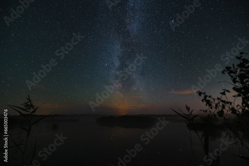 Night scene, milky way over Lake Seli in Estonia.
