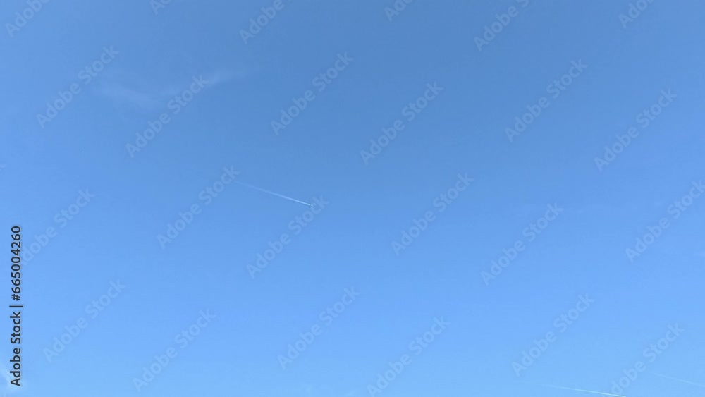 Time lapse sky blue clouds and airplane through long exposure Time lapse sky blue clouds and airplane through long exposure