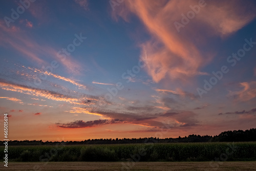 Colorful clouds in summer evening sky. Bright and pink clouds in sky sunset or sunrise. Beautiful purple pink evening sky background. High quality photo