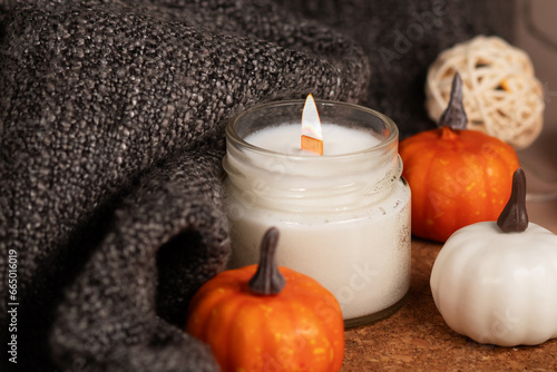 candle and warm blanket, autumn decorations with pumpkins