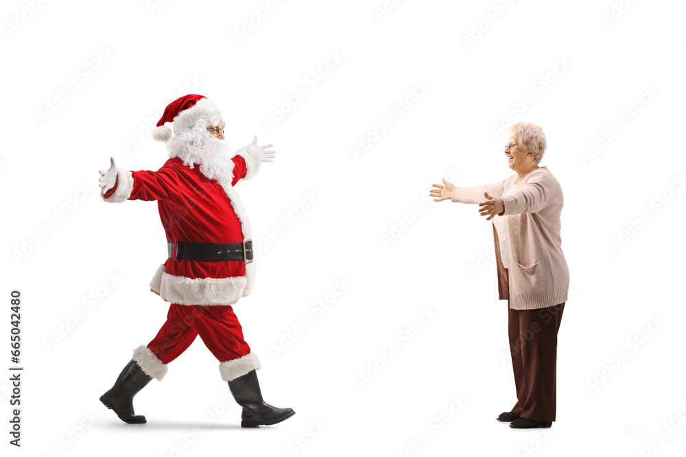 Full length profile shot of santa claus meeting with an elderly woman Full length profile shot of santa claus meeting with an elderly woman