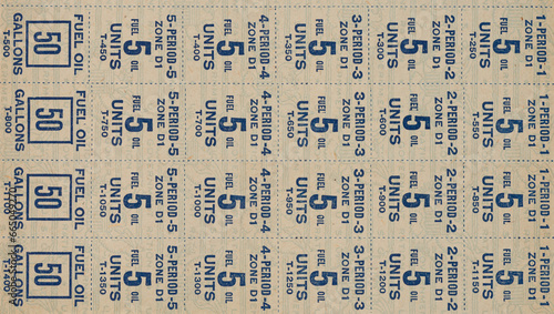 Close up of world war II fuel oil and gas rationing stamps background