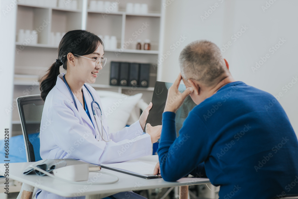 Obraz premium Professional female doctor smiles and shows positive test results to elderly male patient at doctor's appointment in modern office of medical institution